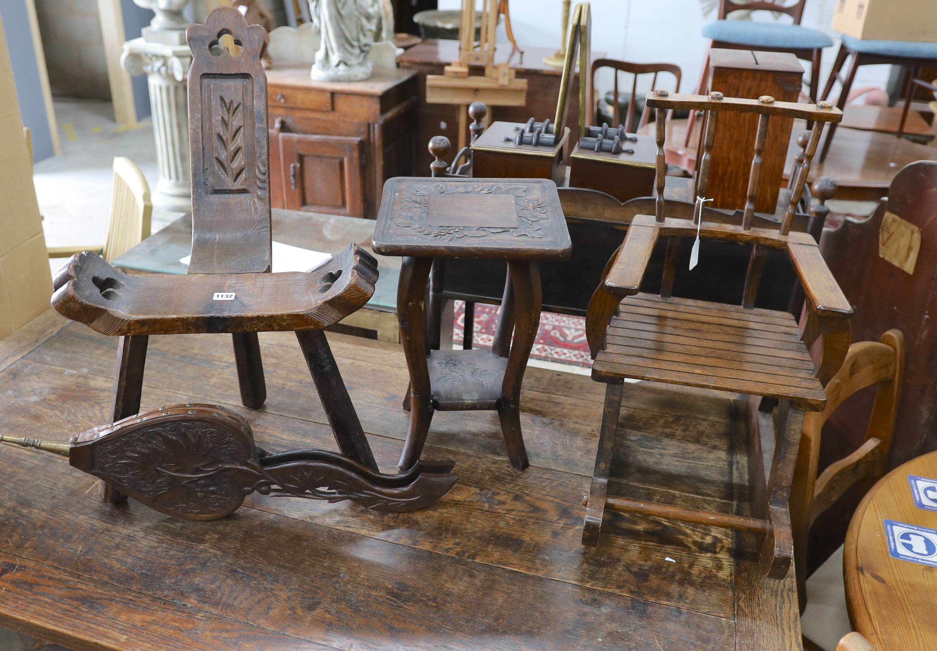 A small child's oak rocking chair, a pair of carved wood bellows and two caned tables